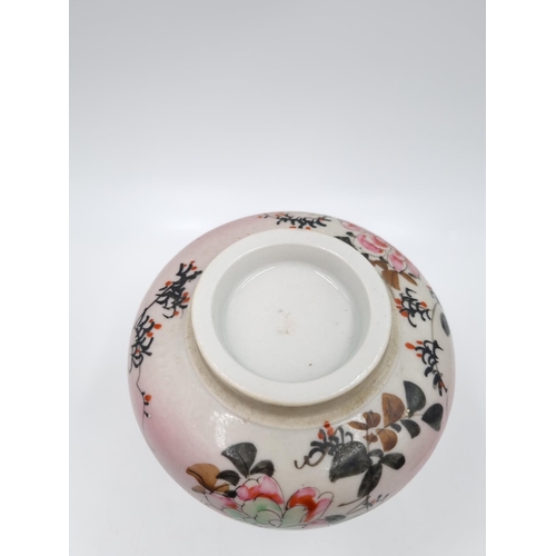 418 - A Japanese porcelain ginger jar and cover decorated with flowers and bird - approx. 14cm high