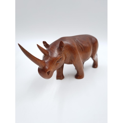 655 - A collection of treenware, three carved hardwood elephant figurines, one carved hardwood rhino figur... 