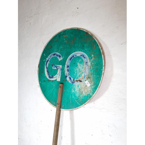 658 - A vintage 'Stop/Go' enamel traffic sign with wooden shaft - approx. 200cm x 60cm in diameter