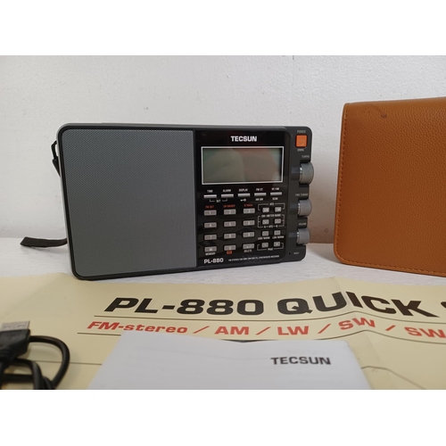 1304 - A cased Tecsun PL-880 multi band radio with instruction manual and radio world map amateur