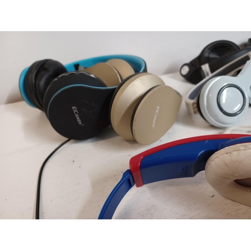 1308 - A large collection of headphones to include eCandy, Skull Candy, JVC, Panasonic RP-WF950H wireless, ... 