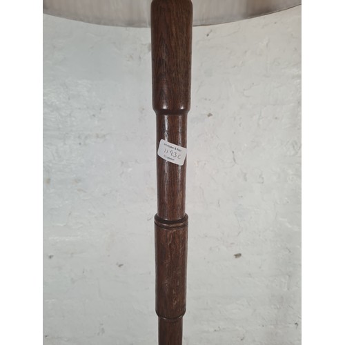 1193C - An oak standard lamp with shade - approx. 178cm high including shade