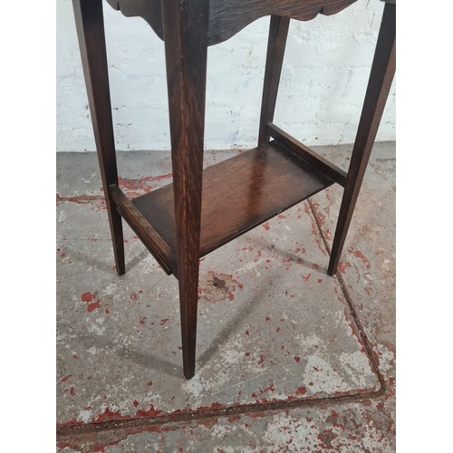 1193D - An early 20th century oak oval top two tier side table - approx. 71cm high x 45cm wide x 62cm long