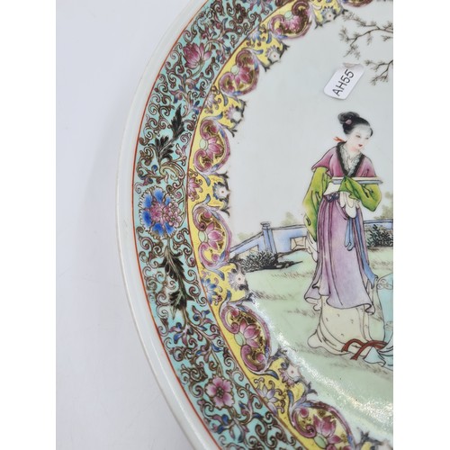 467 - A Chinese Famille Rose porcelain wall charger - approx. 34cm diameter