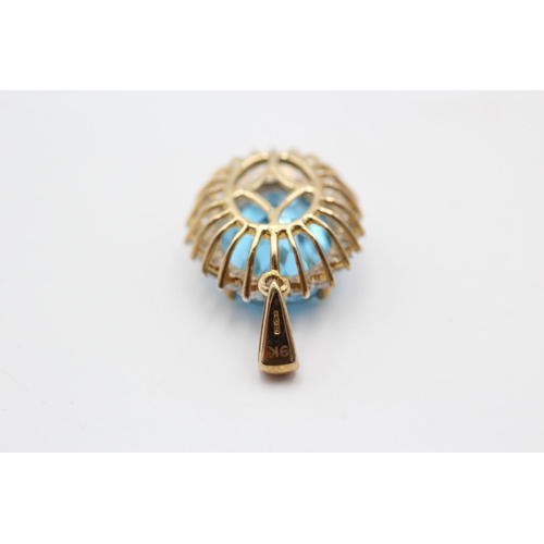 11 - A 9ct gold blue topaz and clear gemstone halo pendant - approx. gross weight 4.7 grams