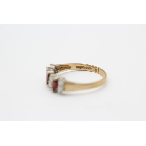 119 - A 9ct gold garnet and clear gemstone dress ring, size T - approx. gross weight 2.1 grams