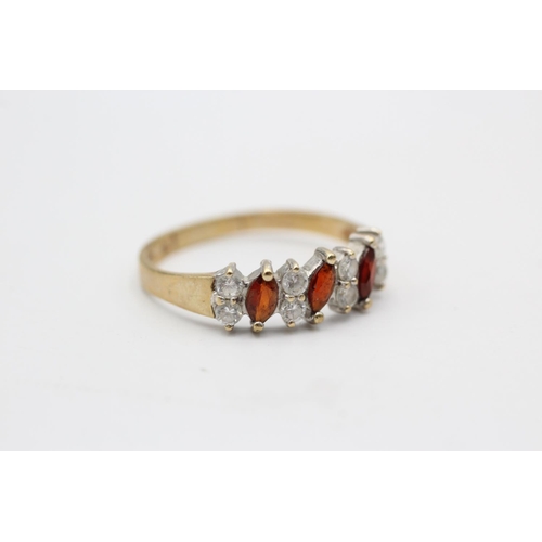 119 - A 9ct gold garnet and clear gemstone dress ring, size T - approx. gross weight 2.1 grams