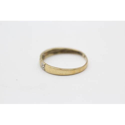 124 - A 9ct gold diamond two row band ring, size O½ - approx. gross weight 0.9 grams