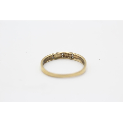 124 - A 9ct gold diamond two row band ring, size O½ - approx. gross weight 0.9 grams