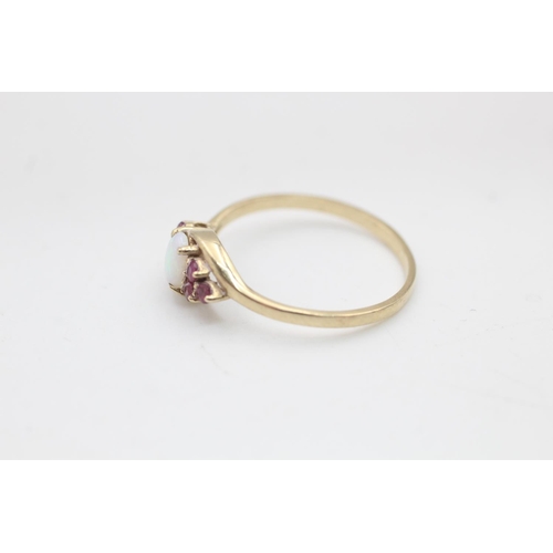 133 - A 9ct gold opal and ruby seven stone twist setting dress ring, size S - approx. gross weight 1.6 gra... 