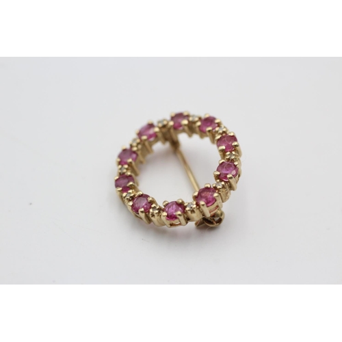 150 - A 9ct gold ruby and diamond halo brooch - approx. gross weight 2.4 grams