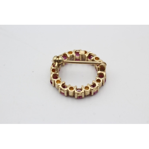 150 - A 9ct gold ruby and diamond halo brooch - approx. gross weight 2.4 grams