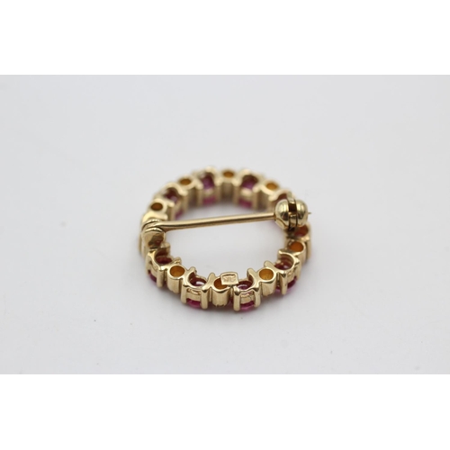 150 - A 9ct gold ruby and diamond halo brooch - approx. gross weight 2.4 grams