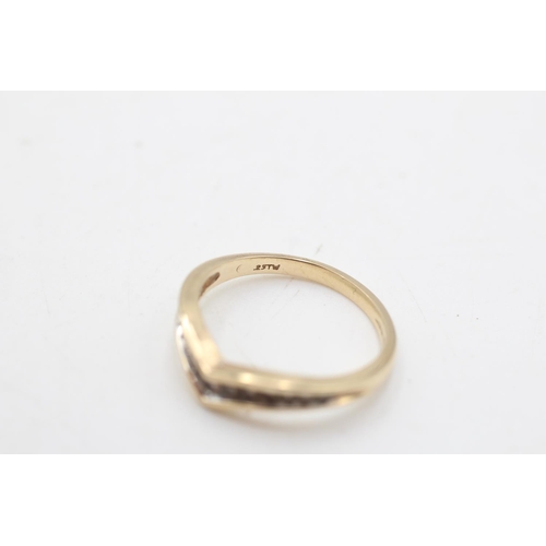 27 - A 9ct gold diamond channel set wishbone ring, size O½ - approx. gross weight 2.3 grams