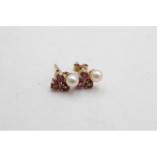 64 - Two pairs of 9ct gold pearl and gemstone stud earrings, one ruby and one sapphire - approx. gross we... 