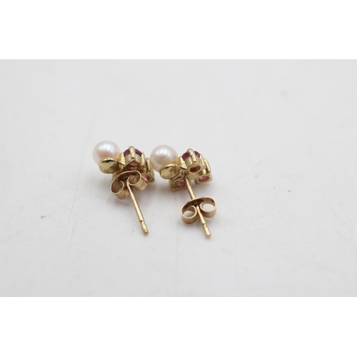 64 - Two pairs of 9ct gold pearl and gemstone stud earrings, one ruby and one sapphire - approx. gross we... 