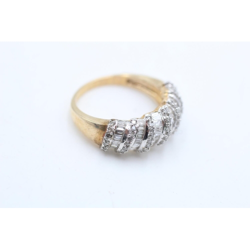 69 - A 9ct gold diamond baguette and round cut dress ring, size P - approx. gross weight 5.1 grams