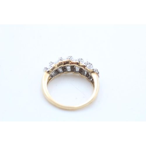 69 - A 9ct gold diamond baguette and round cut dress ring, size P - approx. gross weight 5.1 grams