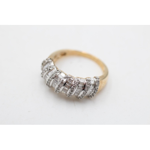 69 - A 9ct gold diamond baguette and round cut dress ring, size P - approx. gross weight 5.1 grams