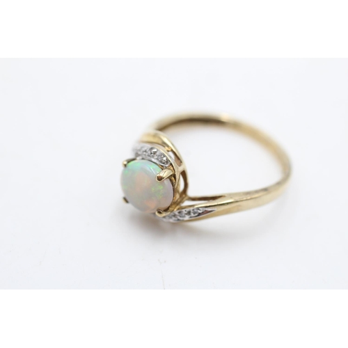 74 - A 9ct gold opal and diamond bypass ring, size S - approx. gross weight 2.7 grams