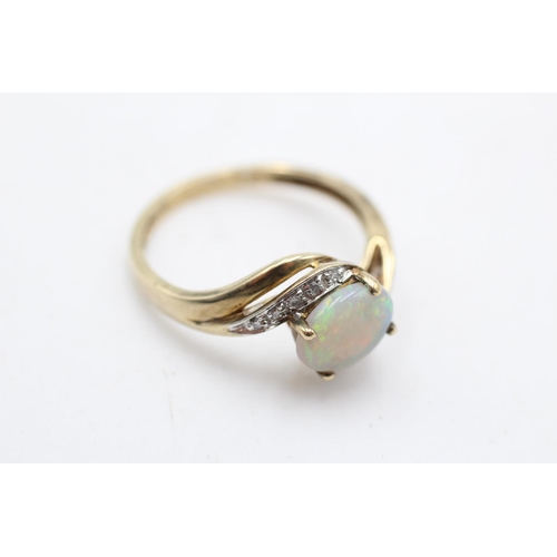 74 - A 9ct gold opal and diamond bypass ring, size S - approx. gross weight 2.7 grams