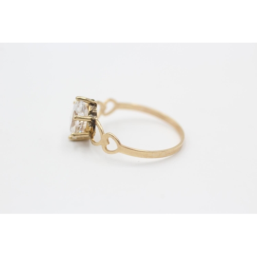 92 - A 9ct gold clear gemstone solitaire ring with openwork heart shoulders, size P½ - approx. gross weig... 