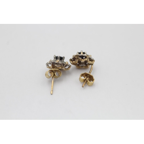 11 - A pair of 9ct gold diamond and sapphire floral cluster stud earrings - approx. gross weight 1.1 gram... 