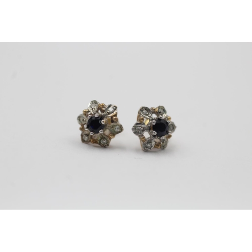 11 - A pair of 9ct gold diamond and sapphire floral cluster stud earrings - approx. gross weight 1.1 gram... 