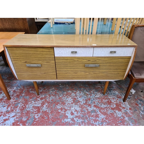 1110 - A mid 20th century melamine cocktail sideboard with fall front, two drawers and single cupboard door... 