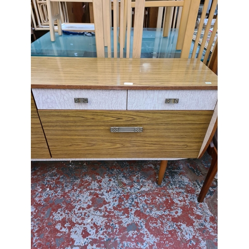 1110 - A mid 20th century melamine cocktail sideboard with fall front, two drawers and single cupboard door... 