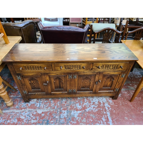 1114 - A Webber Furniture oak sideboard with three upper drawers and four lower cupboard drawers - approx. ... 