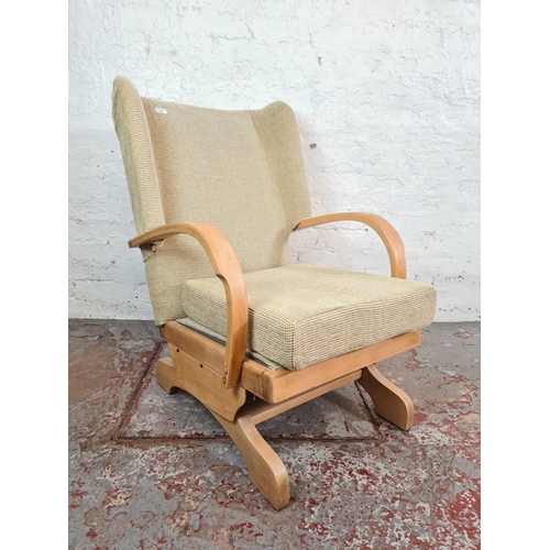 1118 - A mid 20th century beech and beige upholstered rocking armchair - approx. 90cm high x 62cm wide x 66... 