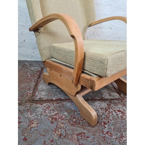 1118 - A mid 20th century beech and beige upholstered rocking armchair - approx. 90cm high x 62cm wide x 66... 