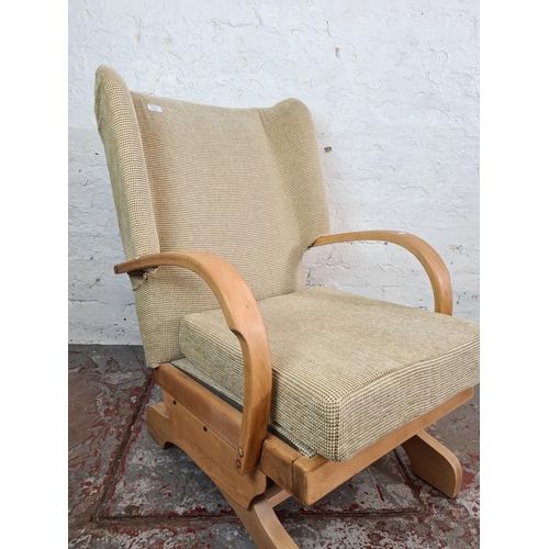 1118 - A mid 20th century beech and beige upholstered rocking armchair - approx. 90cm high x 62cm wide x 66... 