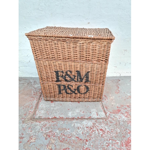 1124 - A large wicker twin handled basket with later added monogram - approx. 76cm high x 72cm wide x 50cm ... 