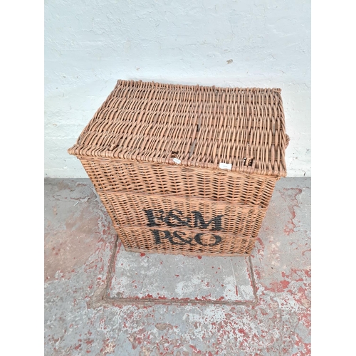 1124 - A large wicker twin handled basket with later added monogram - approx. 76cm high x 72cm wide x 50cm ... 