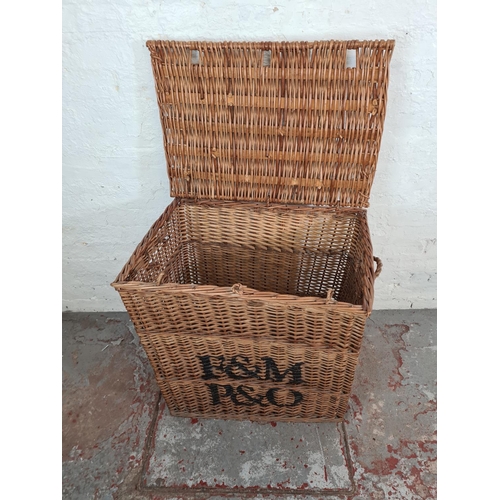 1124 - A large wicker twin handled basket with later added monogram - approx. 76cm high x 72cm wide x 50cm ... 