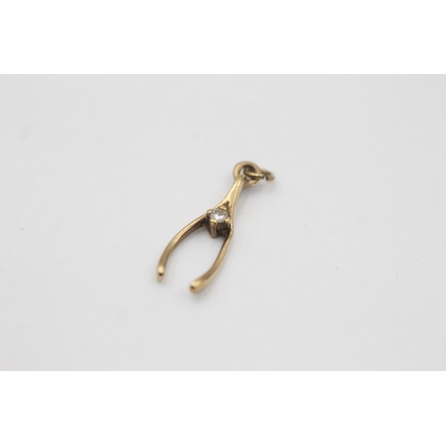 1 - A 9ct gold diamond set wishbone pendant - approx. gross weight 0.7 grams