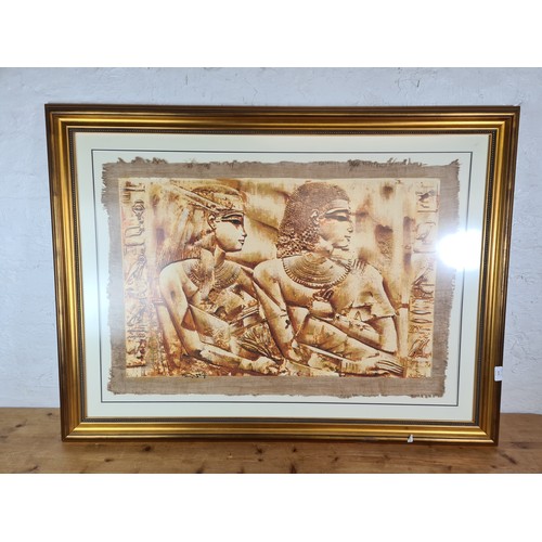 1275 - A gilt framed Egyptian print on parchment paper - approx. 120cm wide x 91cm high