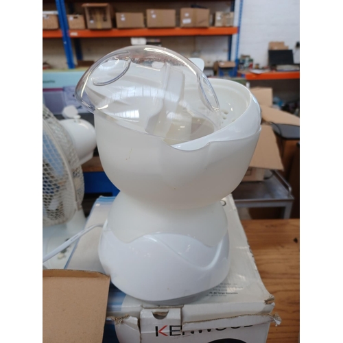 Two boxed items, one Pacific citrus juicer and one Kenwood JE356