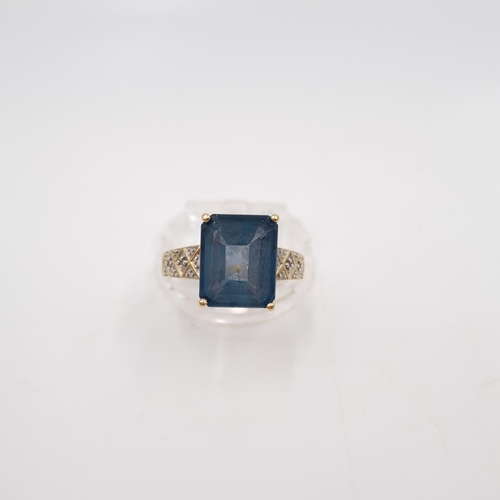 22 - A 9ct gold blue topaz and diamond shouldered ring, size P½ - approx. gross weight 3.85 grams