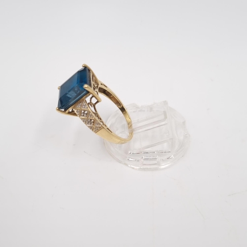 22 - A 9ct gold blue topaz and diamond shouldered ring, size P½ - approx. gross weight 3.85 grams