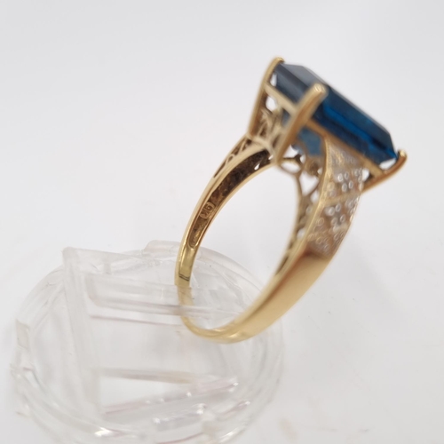 22 - A 9ct gold blue topaz and diamond shouldered ring, size P½ - approx. gross weight 3.85 grams