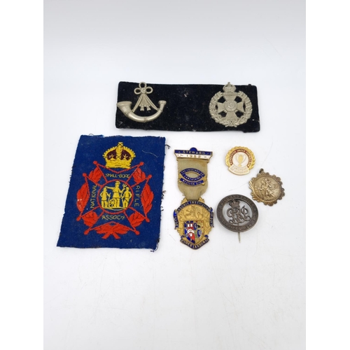 81A - A collection of assorted vintage medals and badges to include Manchester United Football Club Europe... 