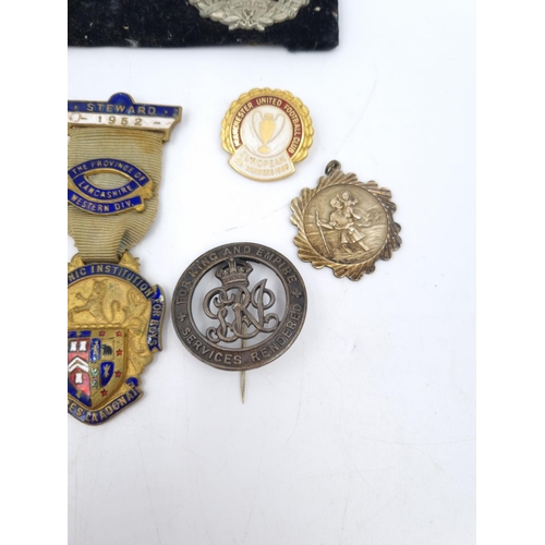 81A - A collection of assorted vintage medals and badges to include Manchester United Football Club Europe... 