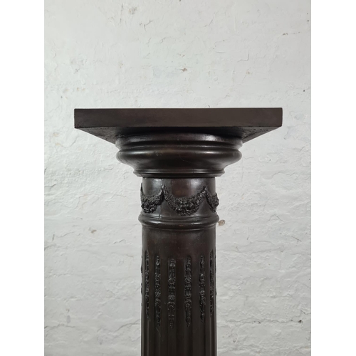 45 - A bronze effect Corinthian column jardinière stand - approx. 104cm high