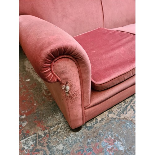 162 - A Victorian pink upholstered two seater drop arm sofa - approx. 75cm high x 155cm wide x 82cm deep