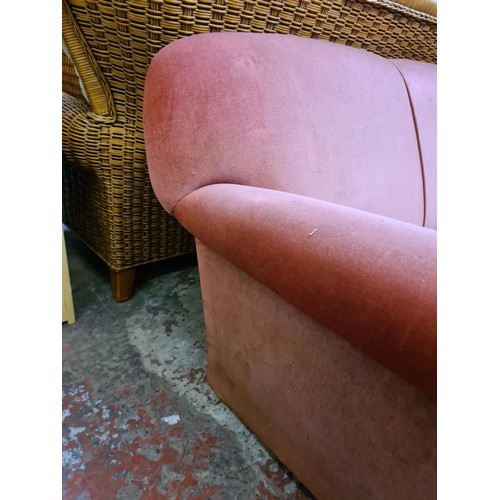 162 - A Victorian pink upholstered two seater drop arm sofa - approx. 75cm high x 155cm wide x 82cm deep