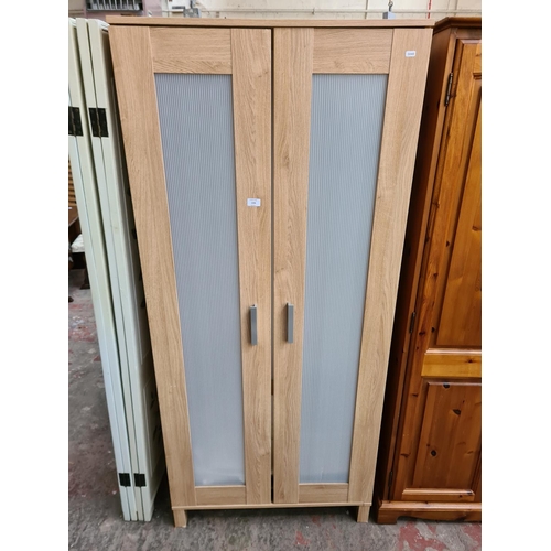 174 - A modern oak effect double wardrobe - approx. 180cm high x 81cm wide x 50cm deep