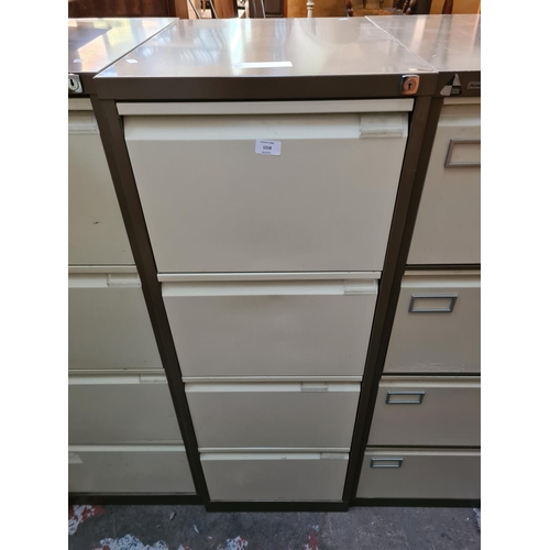 186 - A brown and cream metal four drawer office filing cabinet - approx. 132cm high x 47cm wide x 62cm de... 